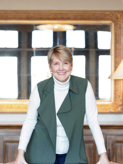 Margaret King Coaching Margaret King Smiling by a desk